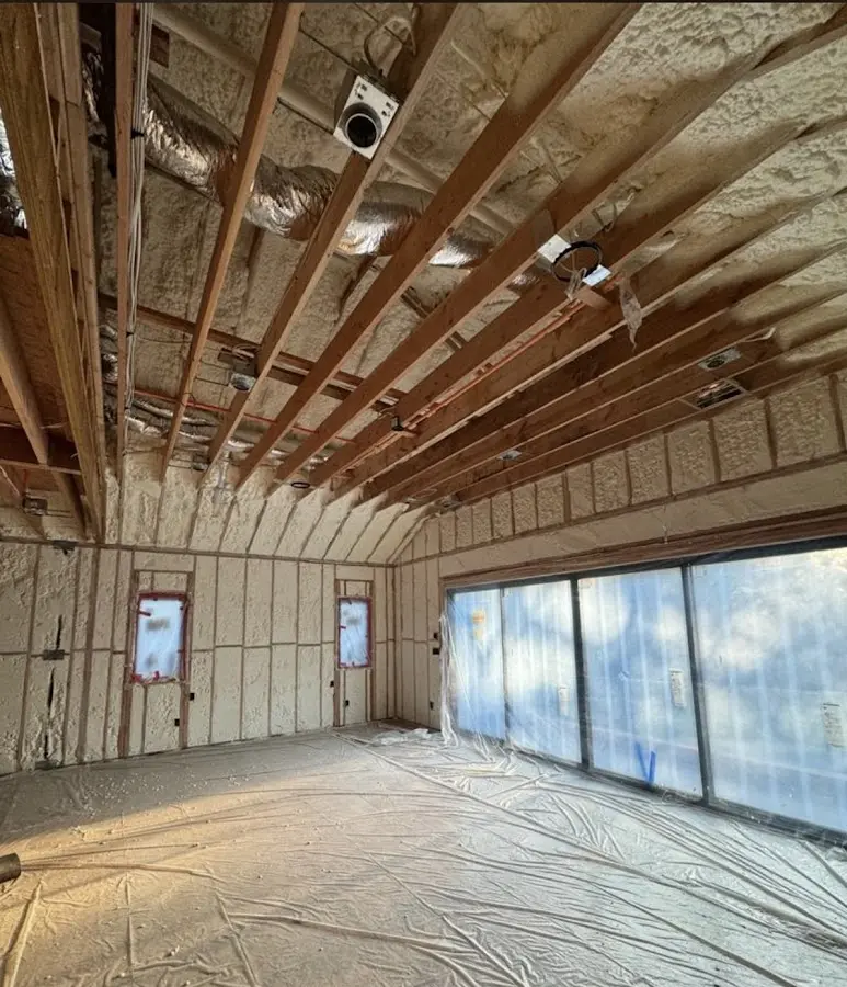 Interior walls and ceiling insulated with spray foam during new construction in Westport